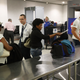 Travelers go through a security point at Miami International Airport on June 2, 2016. (Joe Raedle/Getty Images)
